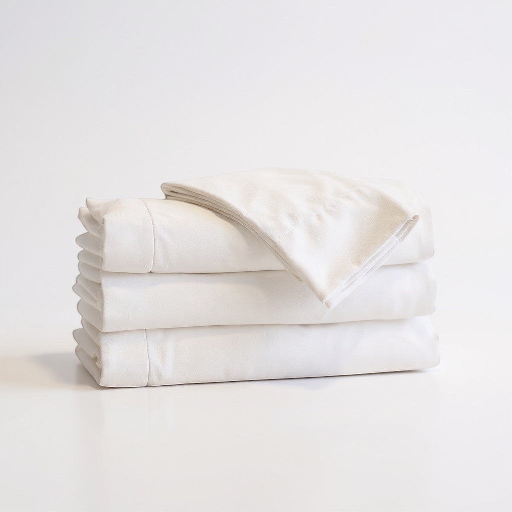 Valiant Products Millennium white 250 thread count percale flat sheets folded in a neat stack.