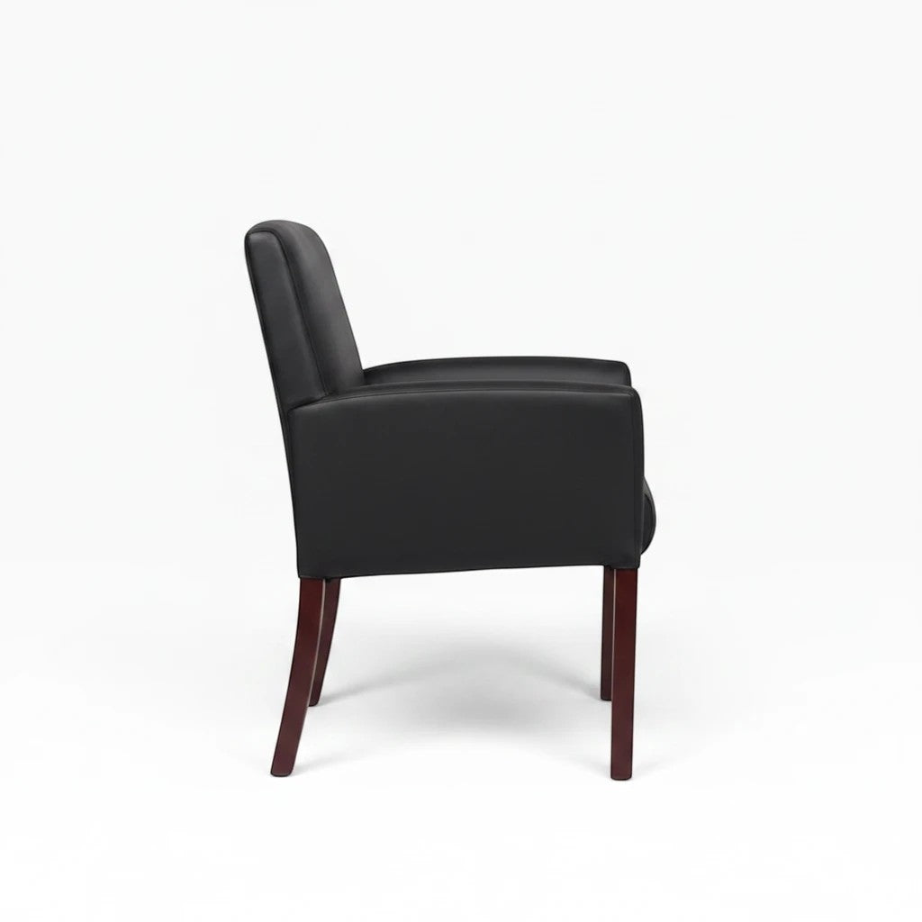 Valiant Products Perrin guest chair in black vinyl with mahogany legs, featuring ergonomic lumbar support and armrests.