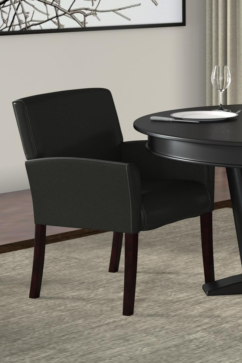 Valiant Products Perrin black vinyl guest chair with mahogany legs and ergonomic lumbar support in a dining setting