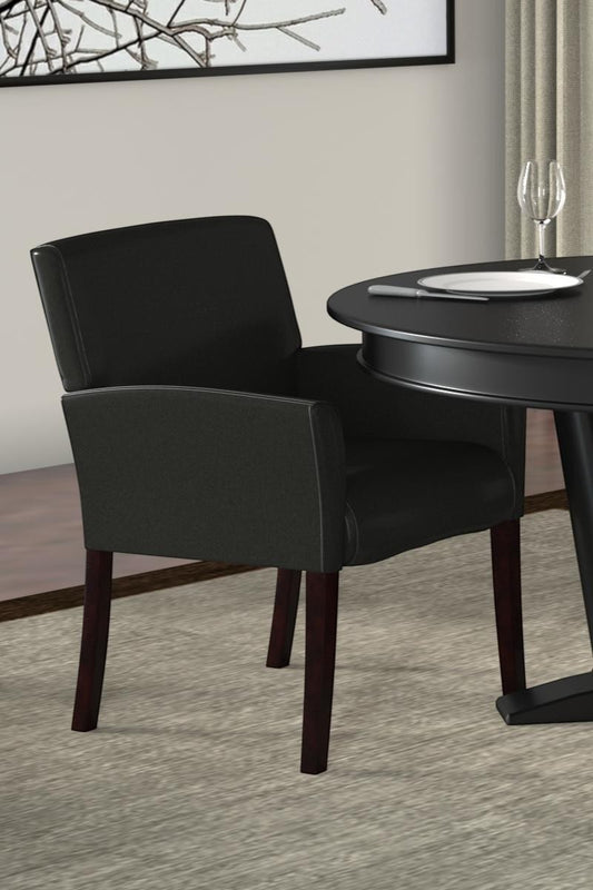Valiant Products Perrin black vinyl guest chair with mahogany legs and ergonomic lumbar support in a dining setting