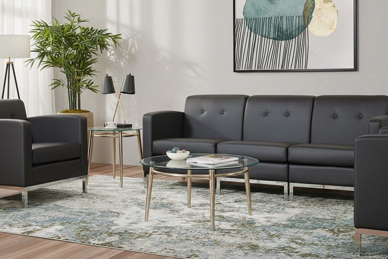 Valiant Products Brooklyn round coffee table with clear glass top and brushed nickel metal legs in a modern living room