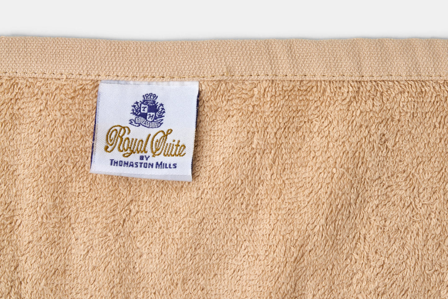 Valiant Products Royal Suite bath towel featuring a soft tan cotton texture and a branded fabric label