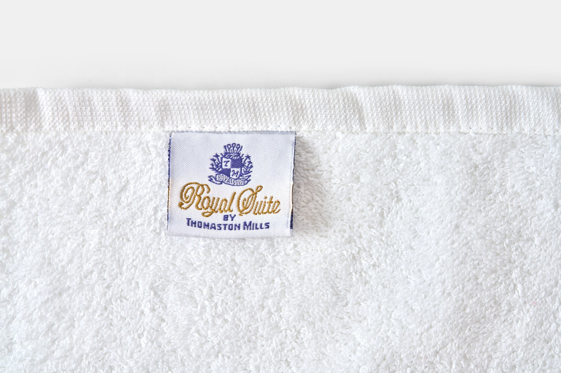 Valiant Products Royal Suite white cotton blend bath towel with embroidered brand label and hemmed edge