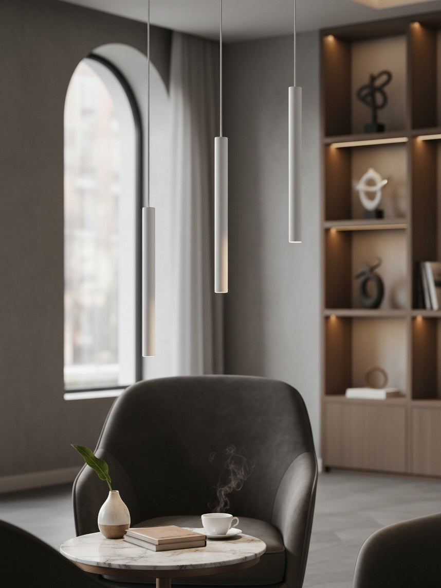 Valiant Products Satori matte white LED pendant lights hanging in a modern living room with a cozy armchair