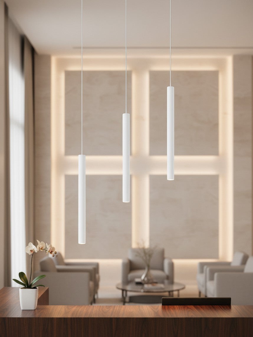 Valiant Products Satori LED pendant light fixture in matte white, featuring a slim cylindrical design in a room.