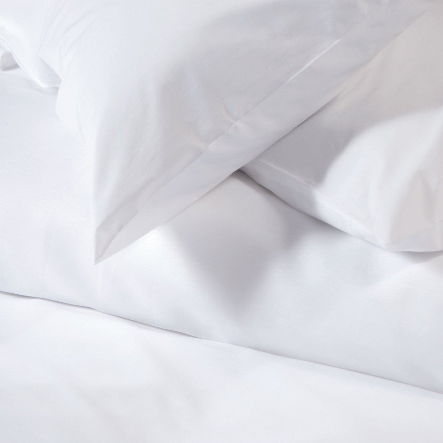 Valiant Products Simplicity 180 thread count white percale fitted sheet and pillowcase set for institutional use.