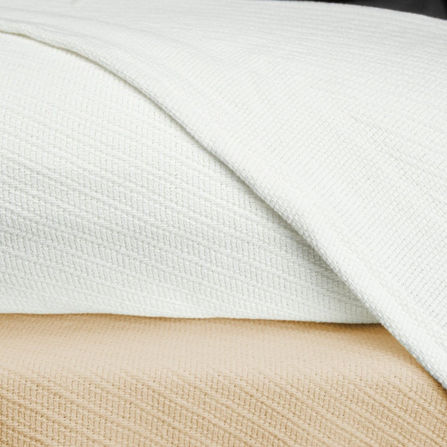 Valiant Products Sovereign 100% cotton blankets in white and natural with a tight diagonal weave texture.