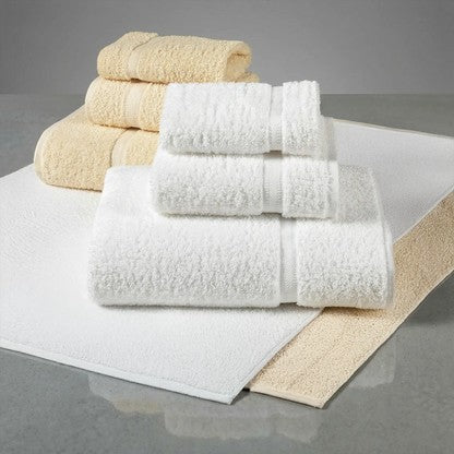 Valiant Products Sovereign dobby border bath towels in white and ecru cotton blend, stacked for hospitality use.