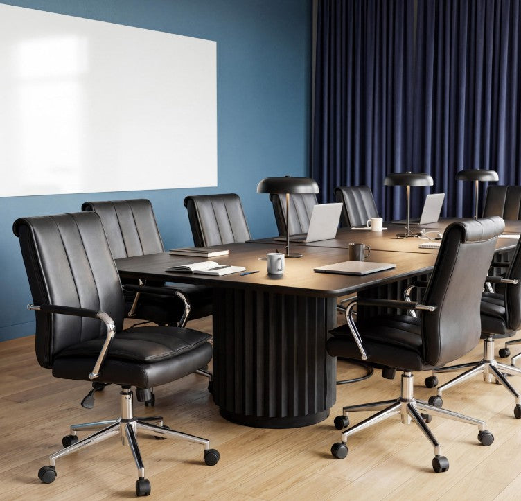 Valiant Products Stanton pillow top ergo chairs with black vinyl upholstery and chrome bases in a modern boardroom.