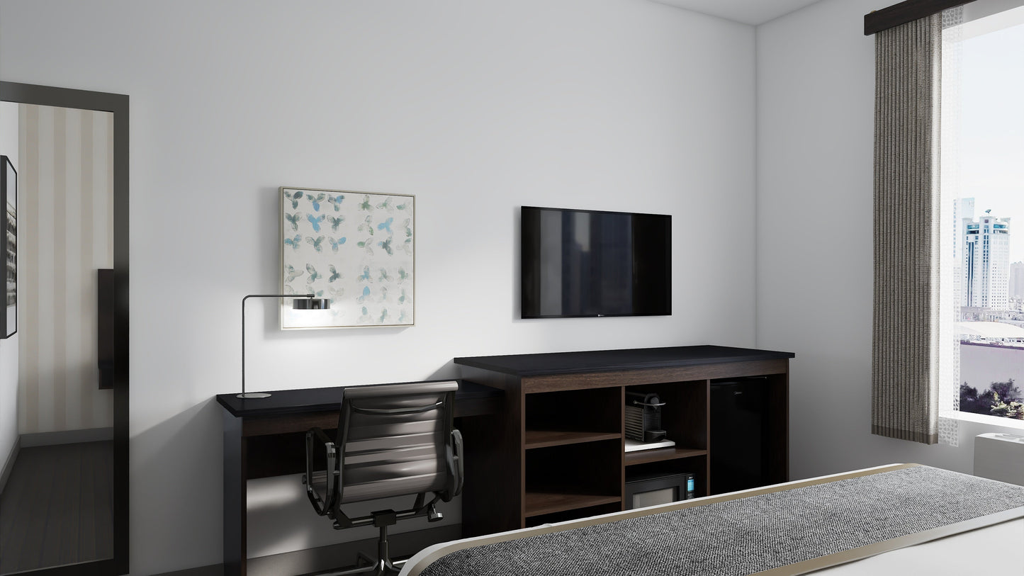 Valiant Products Telluride Unit featuring a dark wood desk and storage console with open shelving in a hotel room.