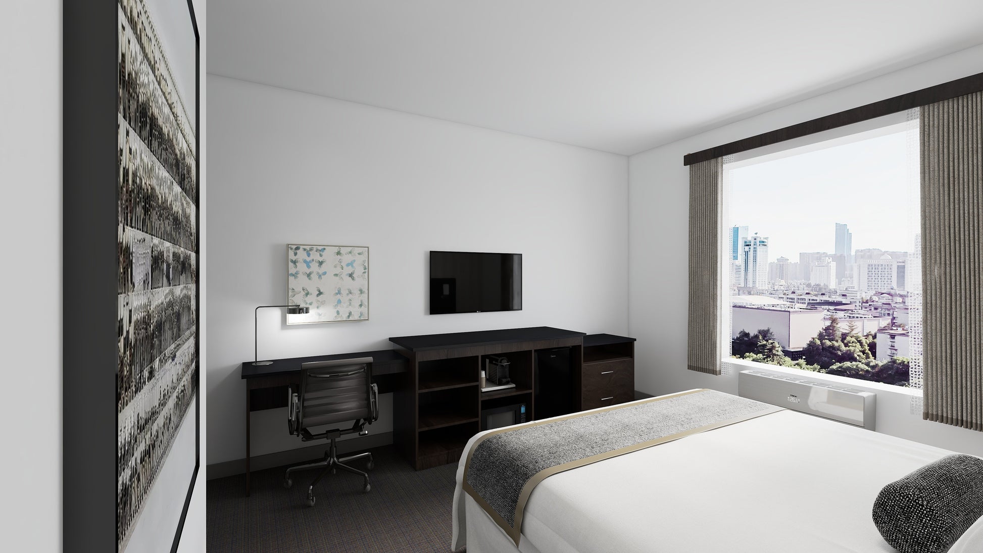 Valiant Products Telluride Unit featuring a desk and appliance console in a modern hotel room with a city view