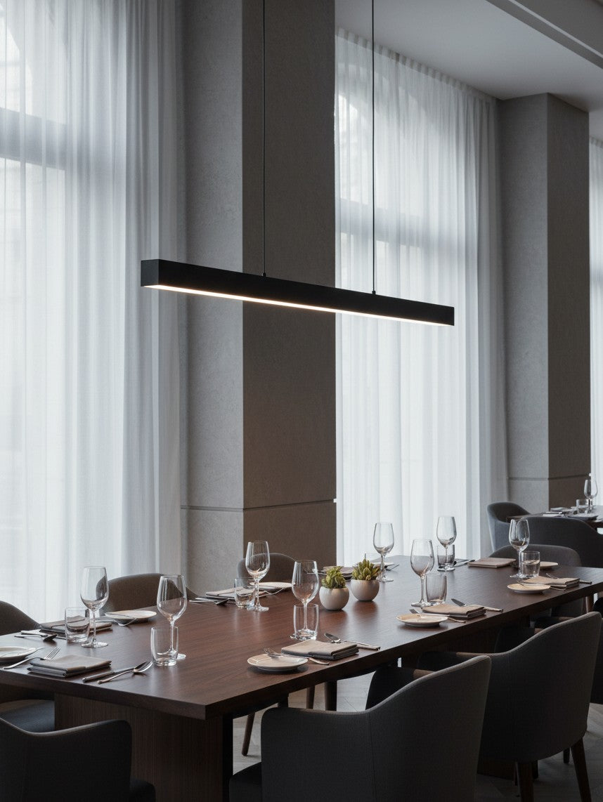 Valiant Products Thread modular matte black LED pendant light fixture hanging over a modern dining room table