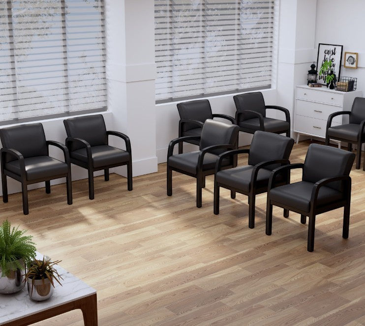Valiant Products Tiernan guest chairs with black antimicrobial vinyl upholstery and black wood frames in an office