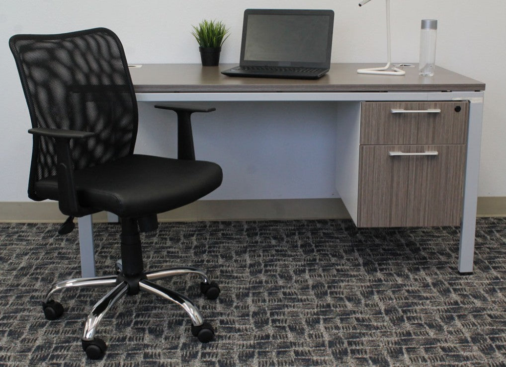 Valiant Products Tilden mesh ergonomic office chair with black vinyl seat and chrome base at a modern desk setup.