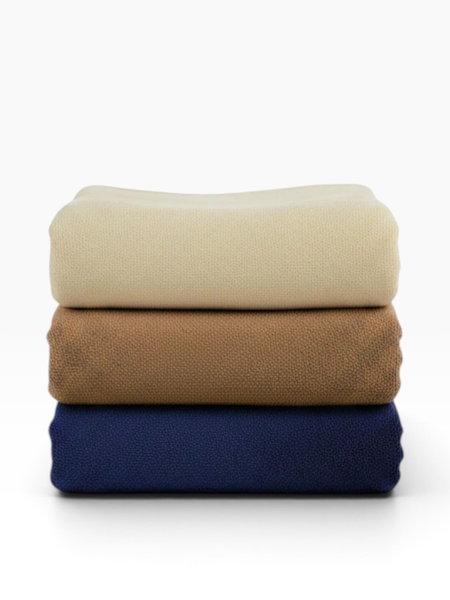 Valiant Products Vellux Renew polyester chenille blankets stacked in navy, tan, and ivory for hospitality use.