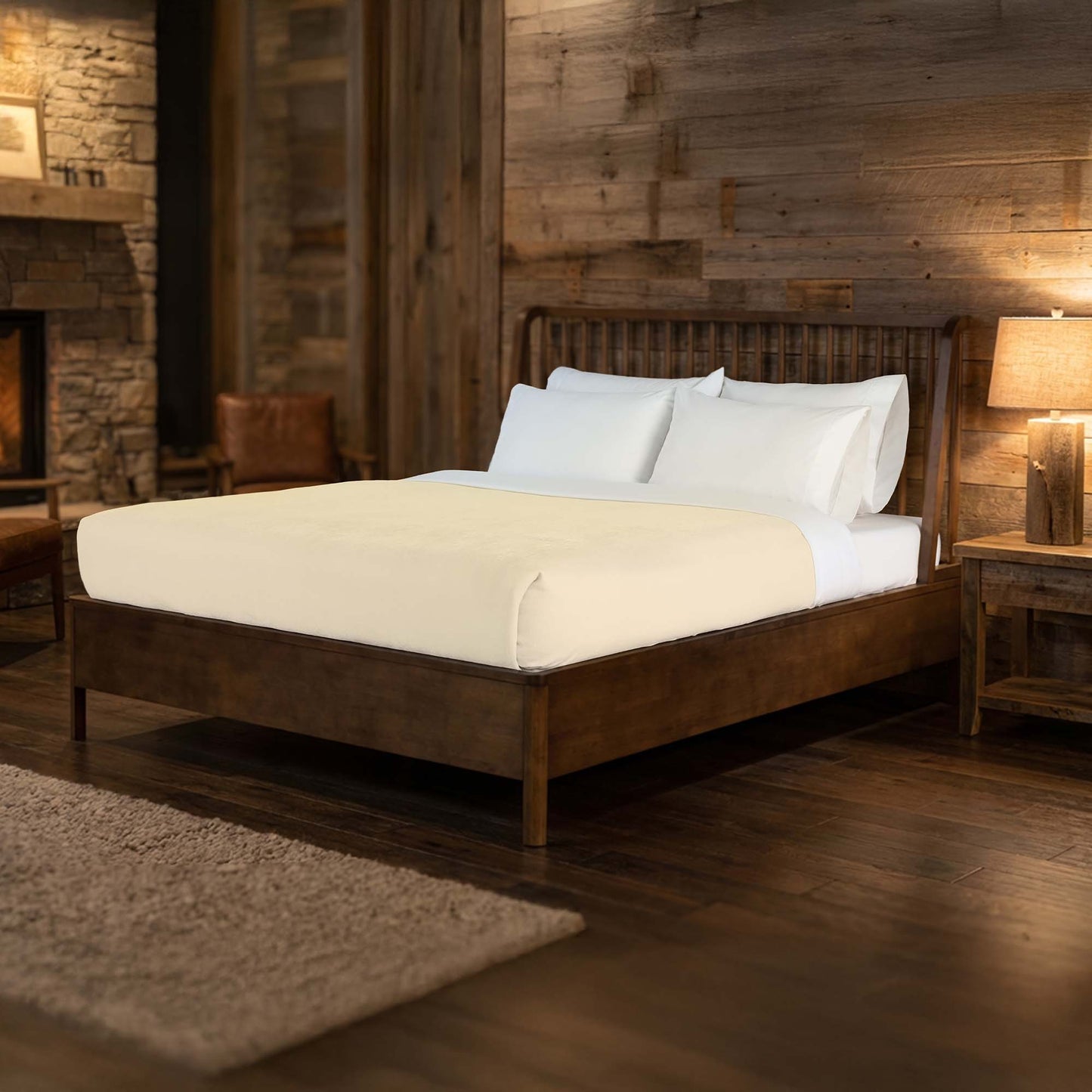Valiant Products Vellux Renew ivory polyester chenille blanket on a wooden bed in a rustic hotel room setting