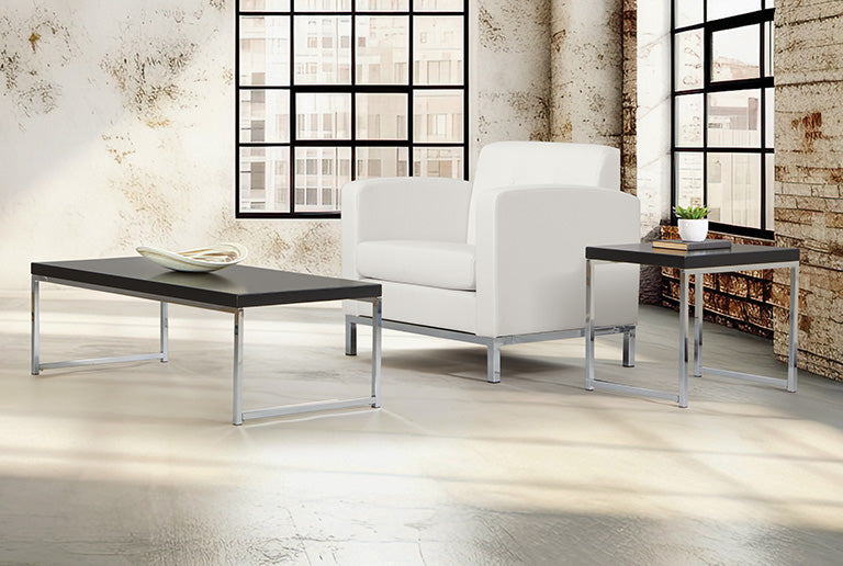 Valiant Products Walden coffee table with a black laminate surface and chrome frame in a modern industrial room