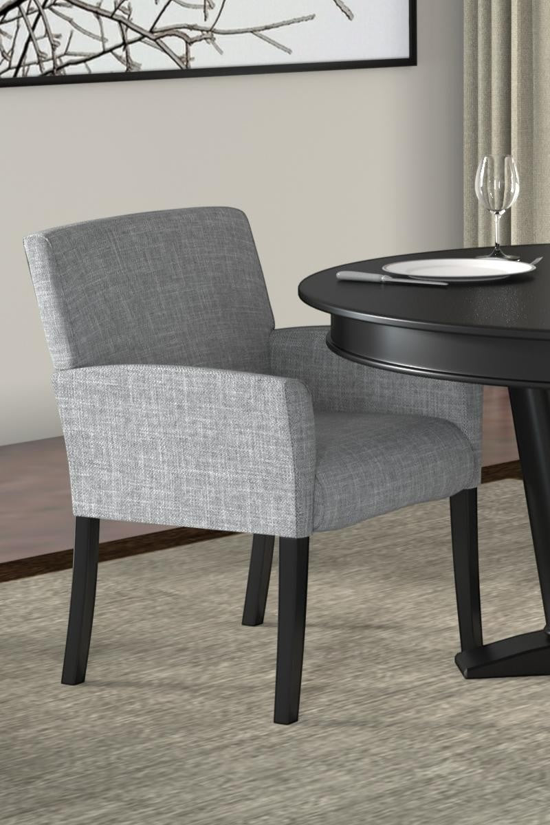 Valiant Products Wexler guest chair in medium grey linen with black wood legs and box arm styling in a dining room.