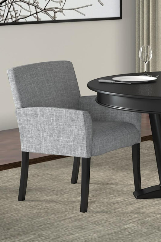 Valiant Products Wexler guest chair in medium grey linen with black wood legs and box arm styling in a dining room.