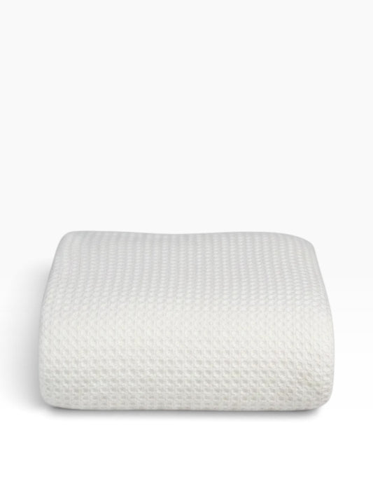 Valiant Products white 100% cotton blanket with a textured basketweave pattern, folded neatly on a white background.