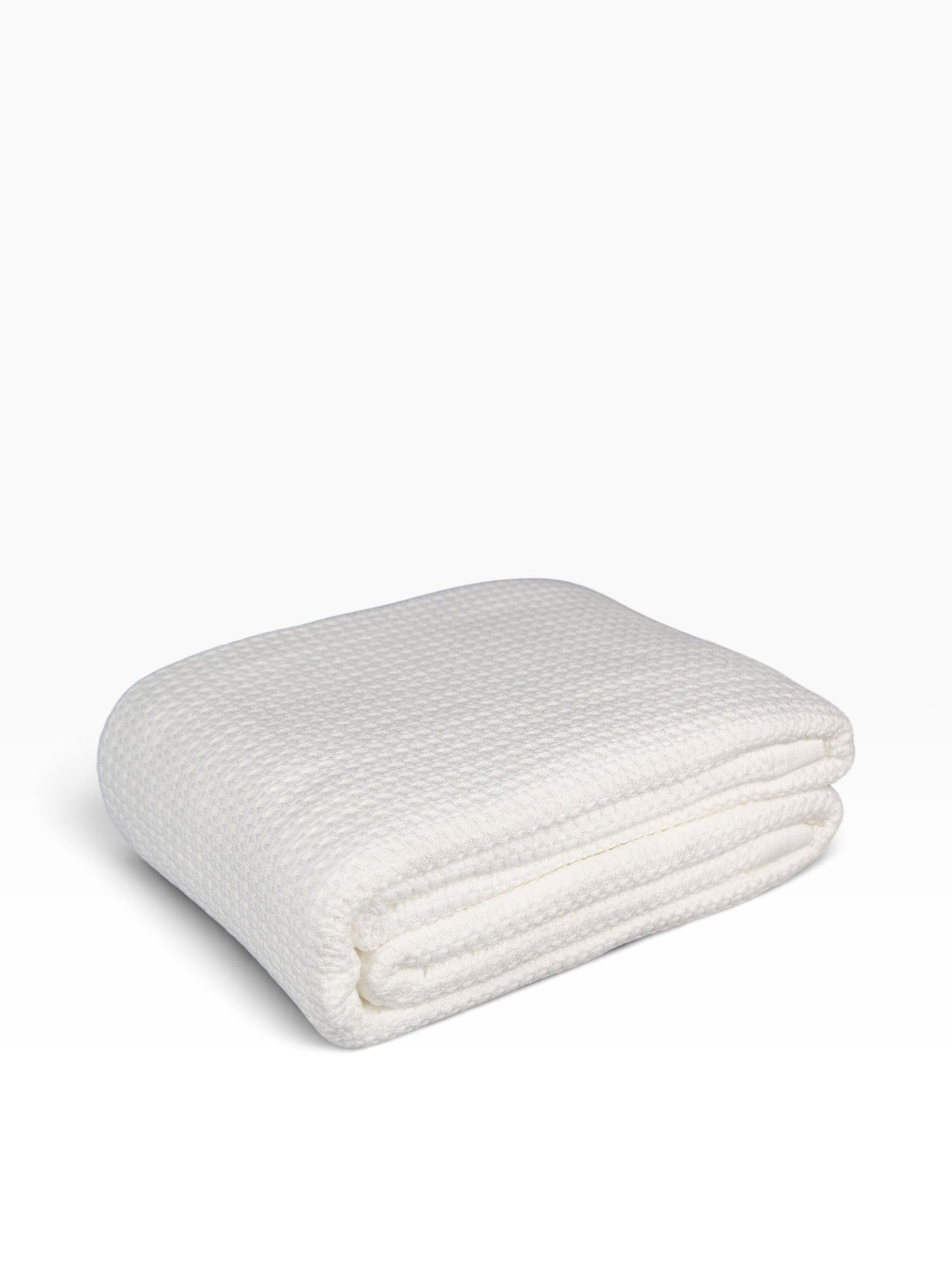 Valiant Products white 100% cotton blanket featuring a luxurious basketweave texture and tailored hemmed finish.