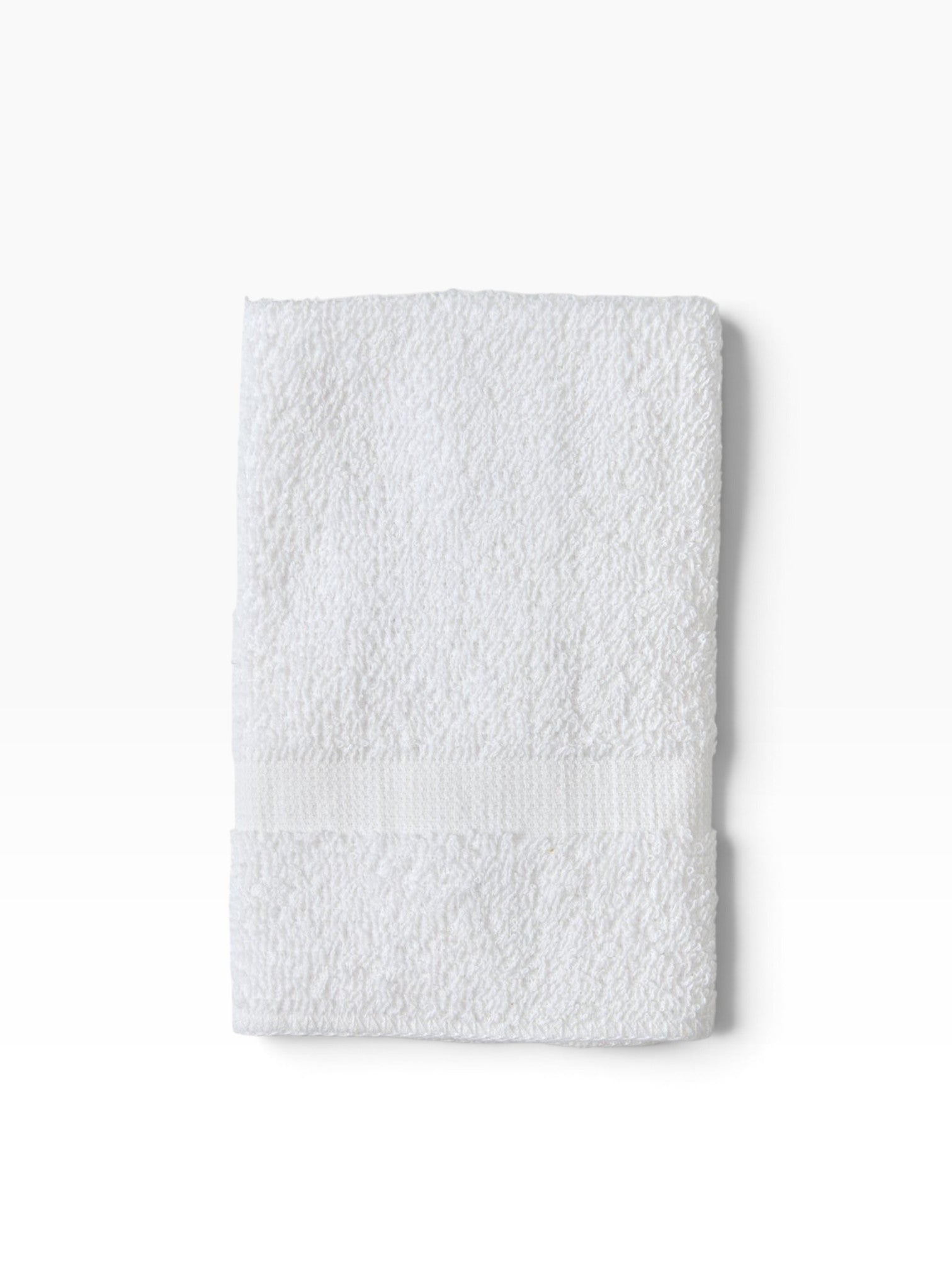 Valiant Products white cotton bath mat with a classic cam border design, featuring soft ring spun cotton loops.