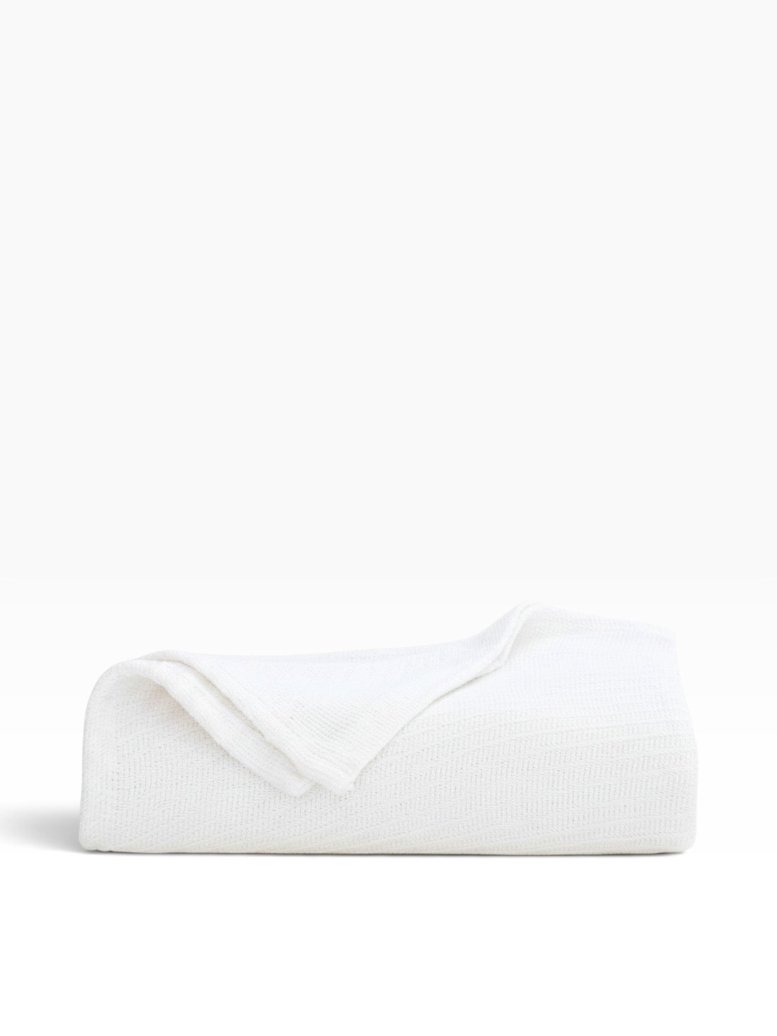 Valiant Products white 100% cotton Sovereign blanket with a tight diagonal weave folded on a white surface