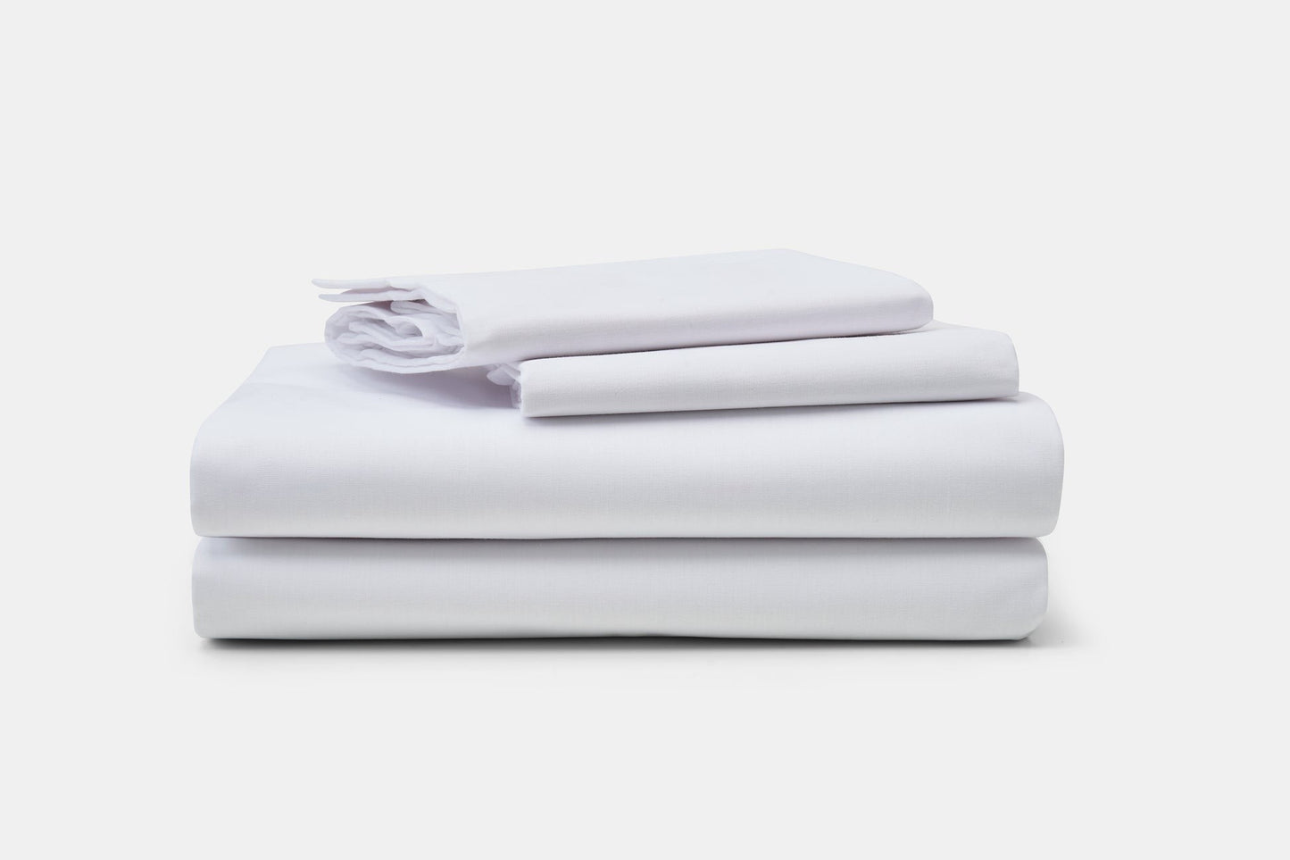 Valiant Products white 180 thread count cotton-polyester blend pillowcases stacked neatly on a plain background