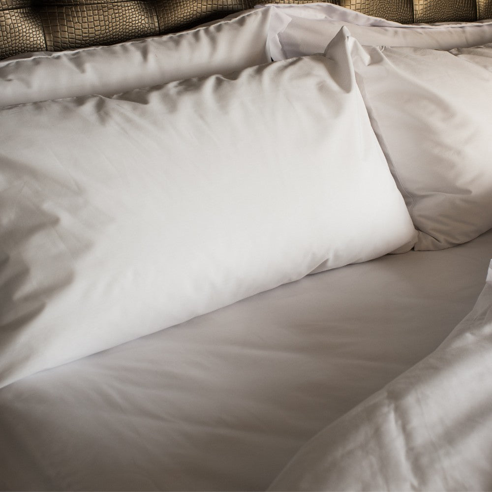 Valiant Products white 300 thread count cotton sateen flat sheet and pillowcase set on a bed