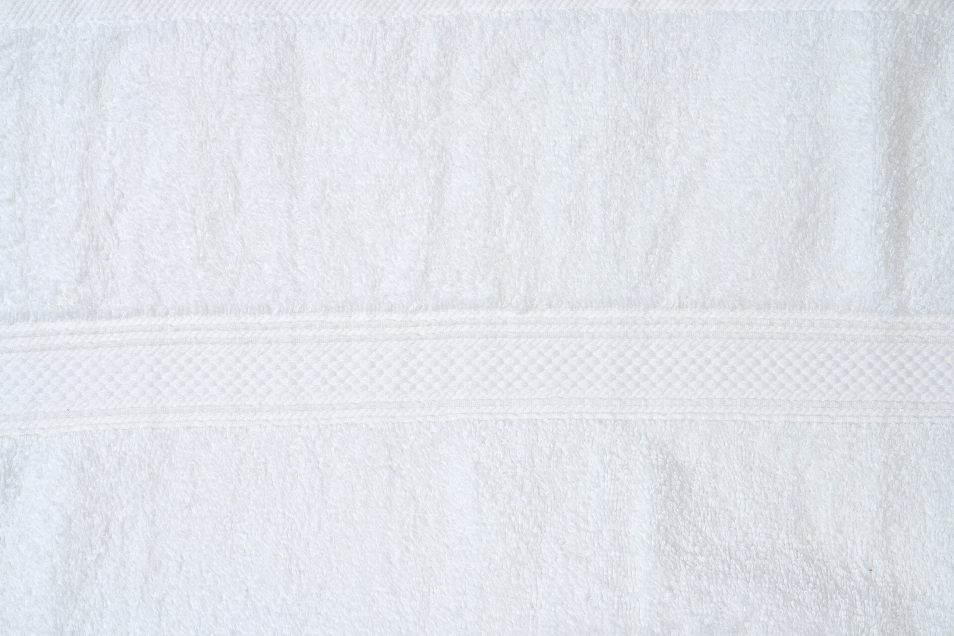 Valiant Products white plush cotton bath mat featuring a textured dobby border design and absorbent pile texture.