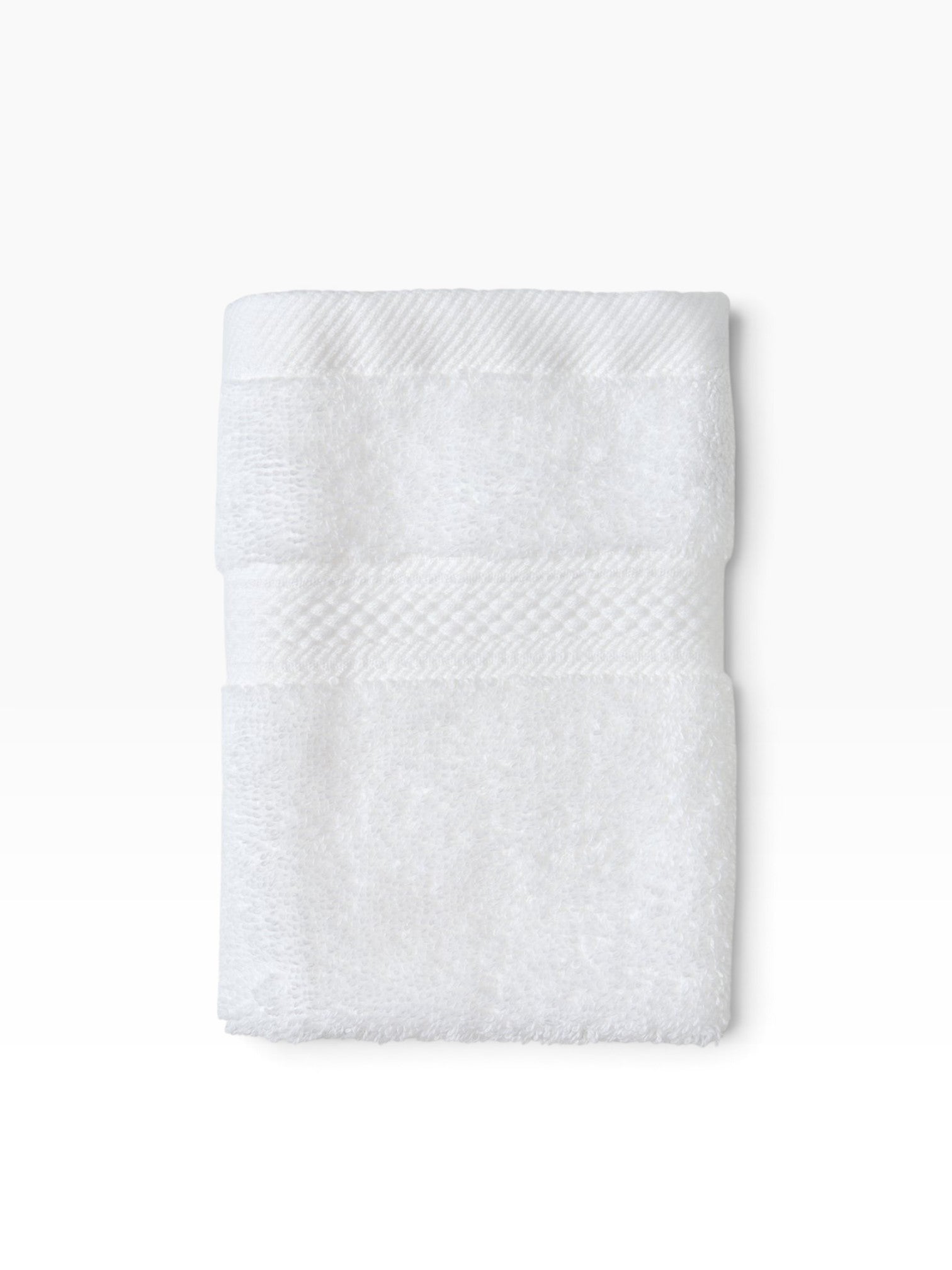 Valiant Products white plush bath towel featuring a decorative dobby border and soft cotton-polyester terry pile.