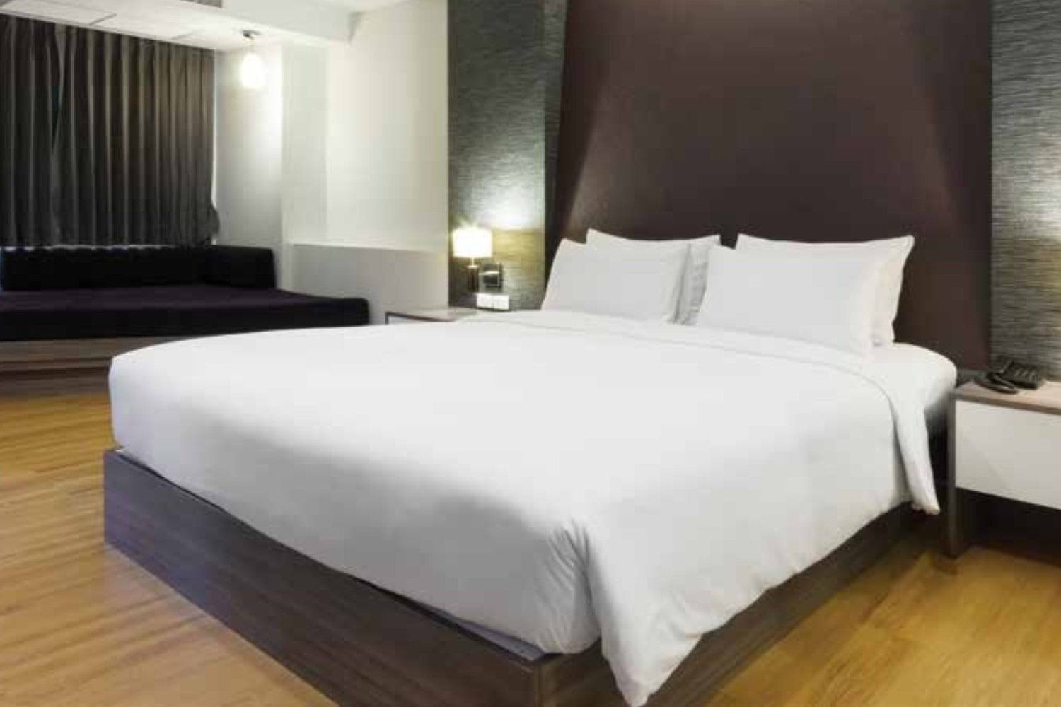 Valiant Products Royal Suite white 300 thread count cotton blend flat sheets on a hotel bed in a modern room