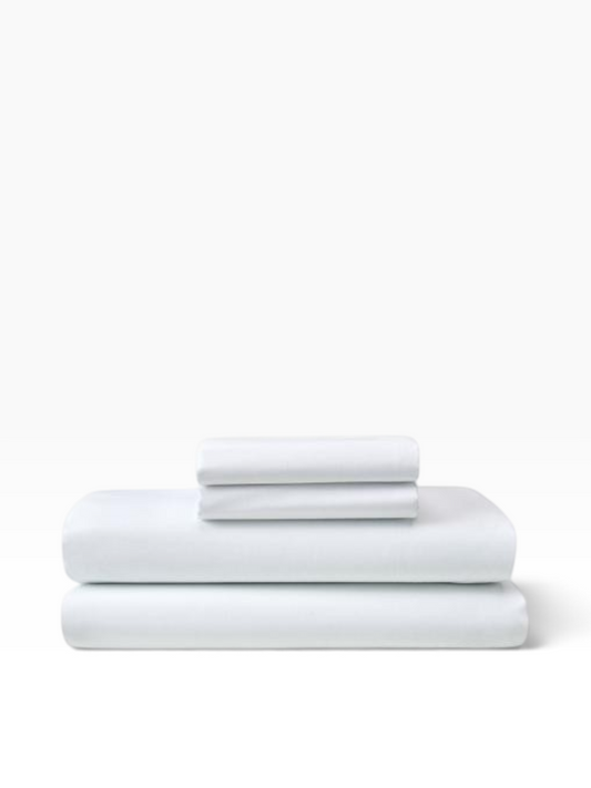 Valiant Products white T-200 thread count flat sheets in a crisp cotton-polyester blend for commercial use.