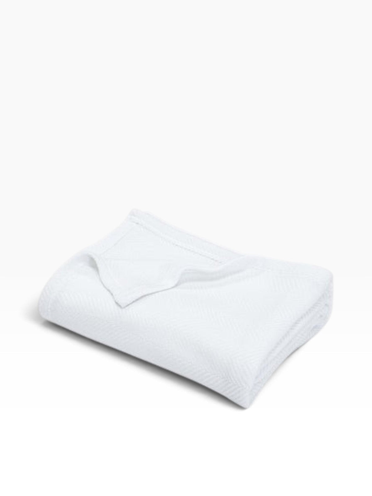 Valiant Products Atelier Luxe white twin blanket featuring a subtle herringbone weave texture.