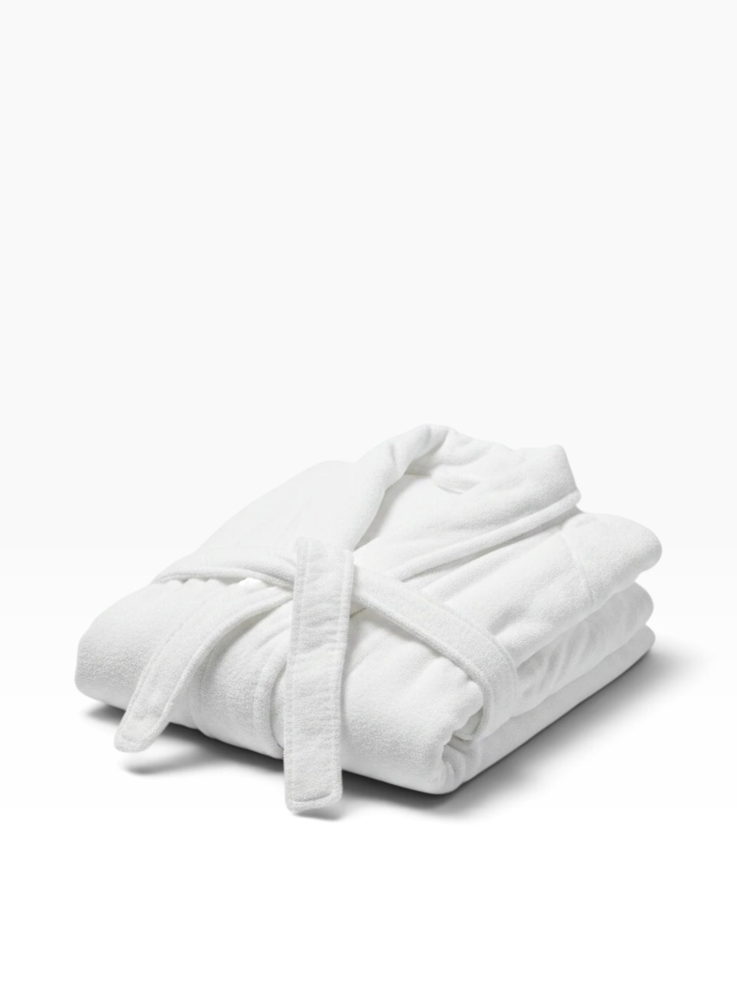 Valiant Products white Ultra Touch hospitality robe with shawl collar and belt, folded neatly on a white background.