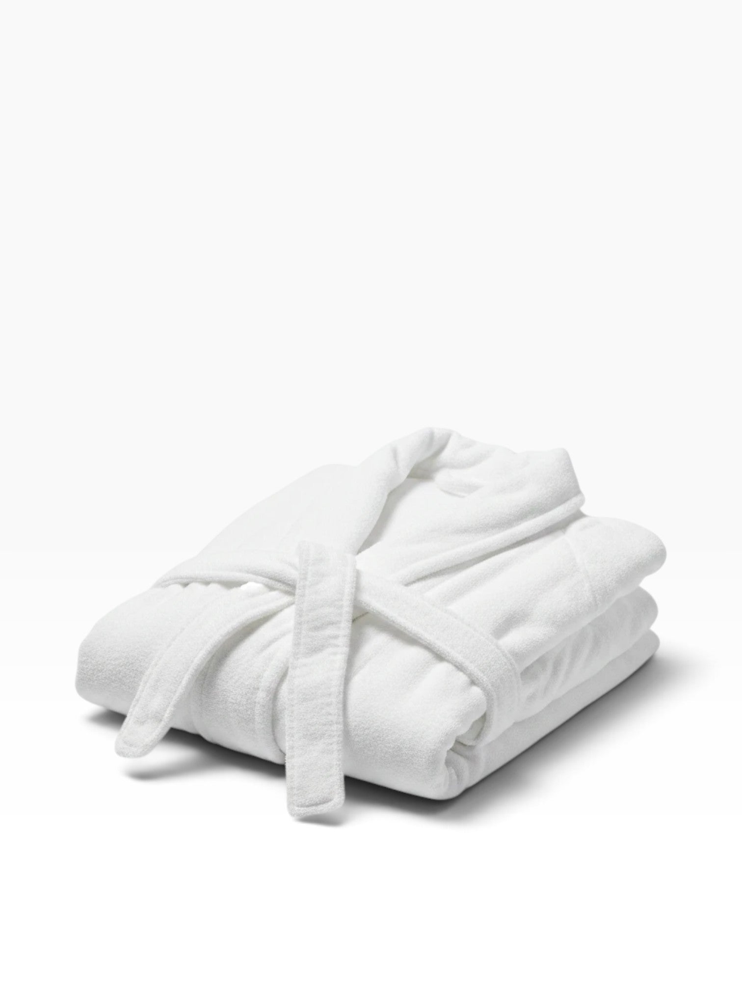Valiant Products white Ultra Touch hospitality robe with shawl collar and belt, folded neatly on a white background.