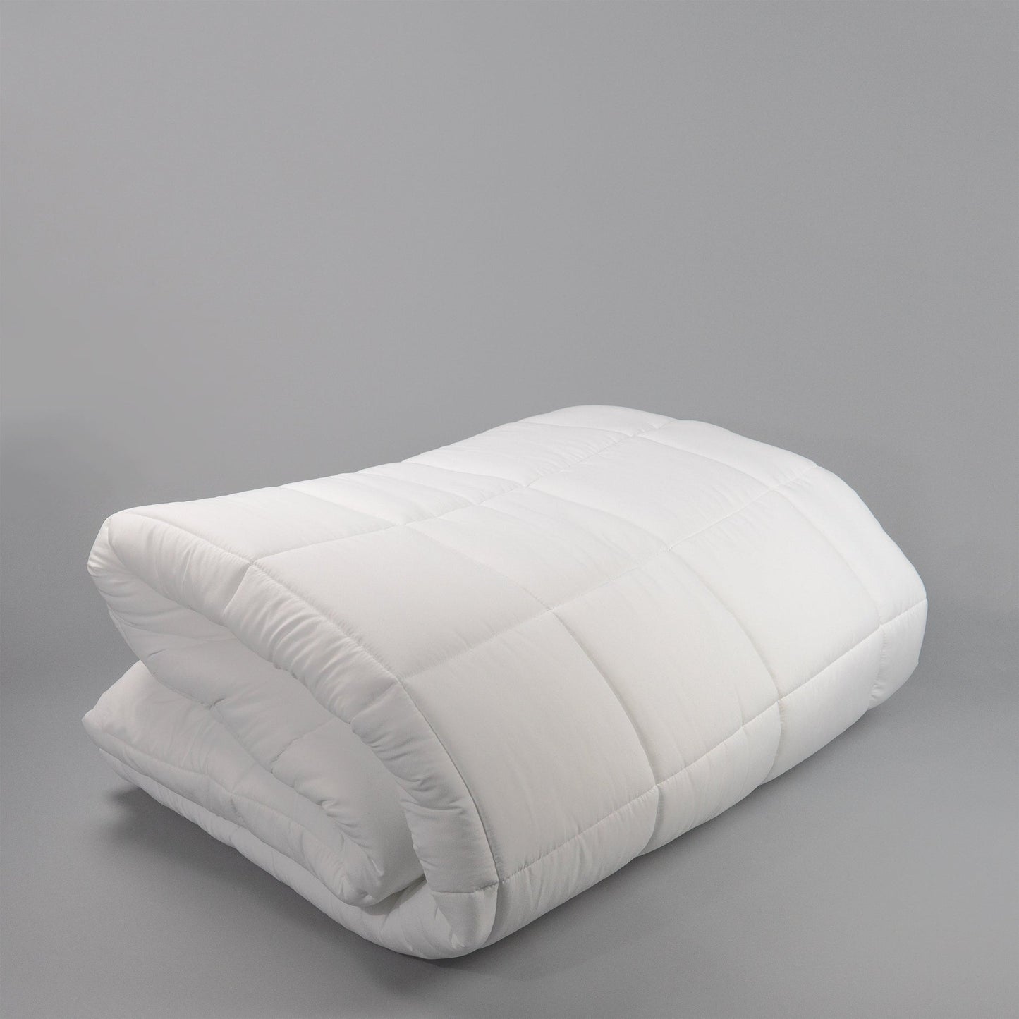 Valiant Products white microfiber down alternative comforter with 8-inch box stitch quilting for hospitality use.