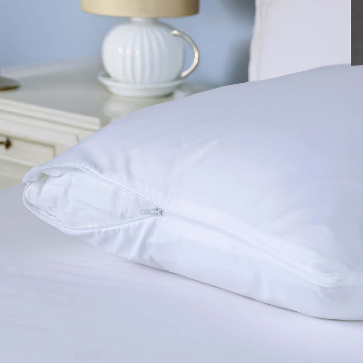 Valiant Products white brushed microfiber pillow protector with a secure nylon zipper closure on a bed