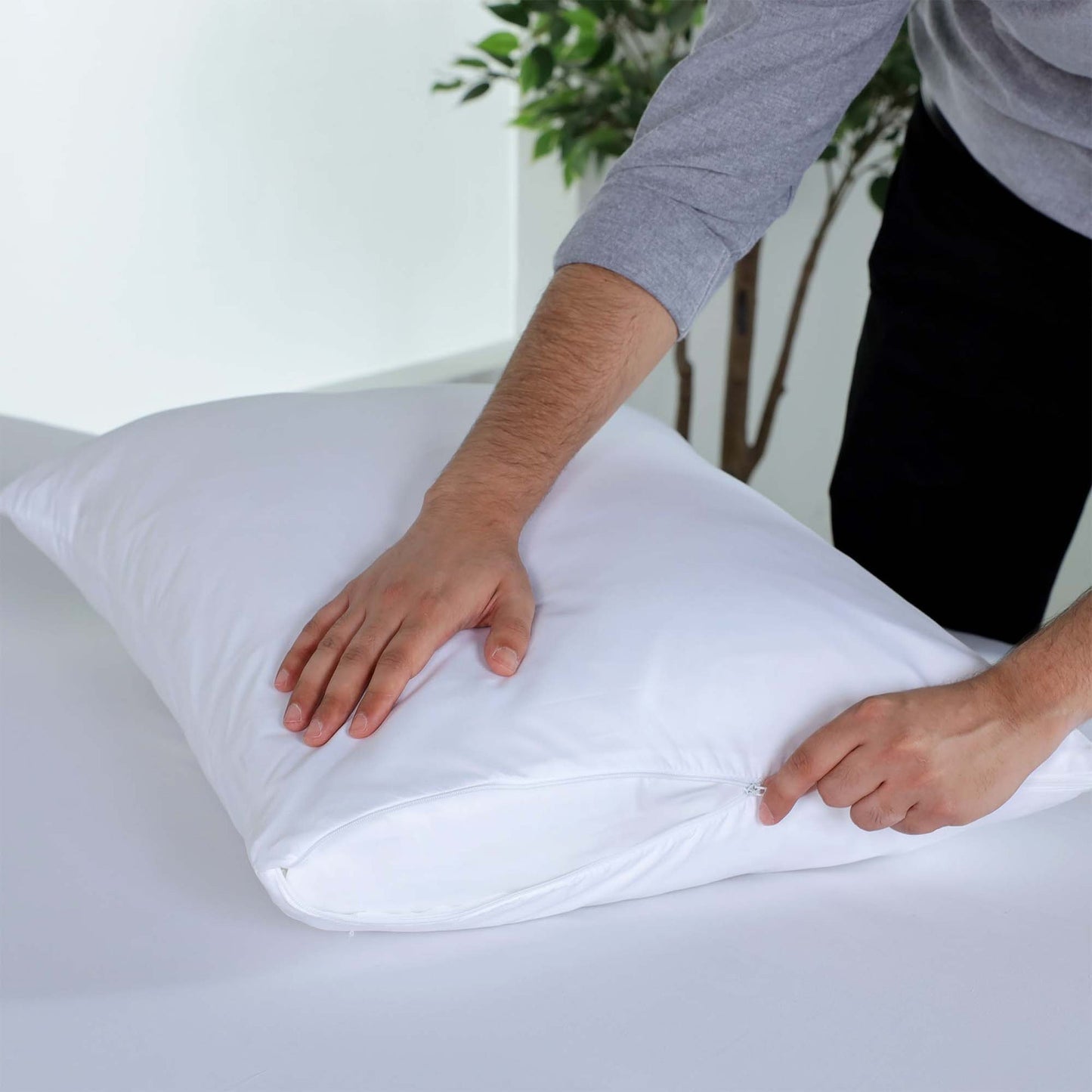 Valiant Products white brushed microfiber pillow protector with a secure nylon zipper closure on a bed