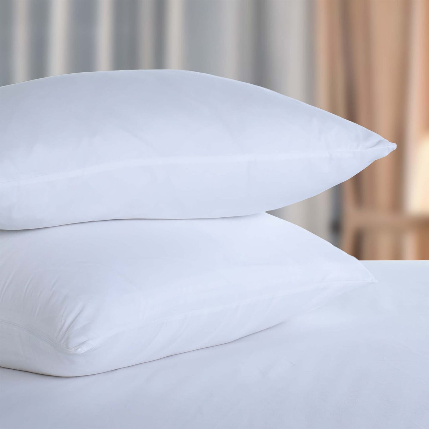 Valiant Products white brushed microfiber pillow protectors stacked on a bed for hospitality use