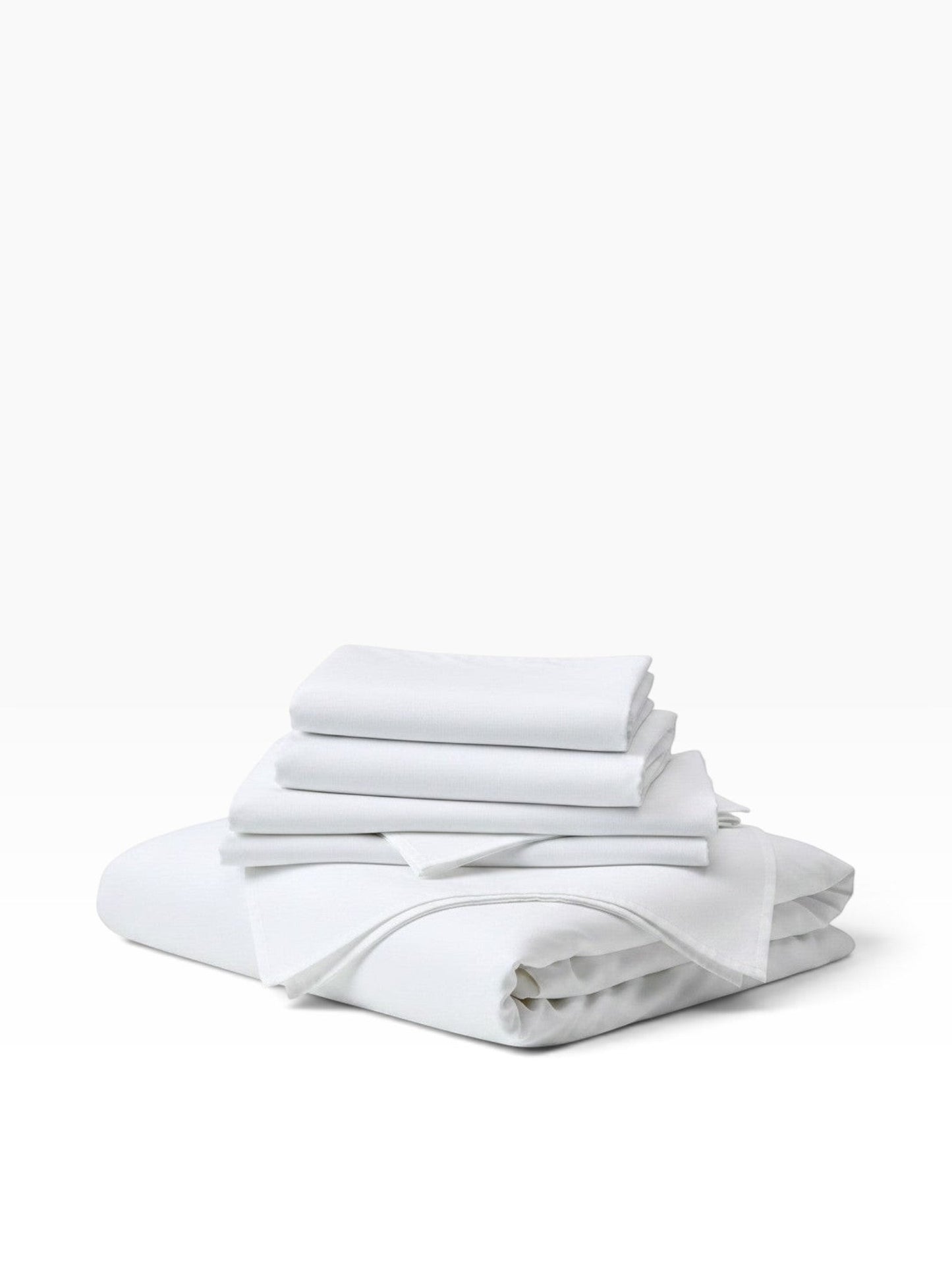 Valiant Products white microfiber pillowcases stacked neatly, featuring a soft brushed finish and durable 3-inch hem.