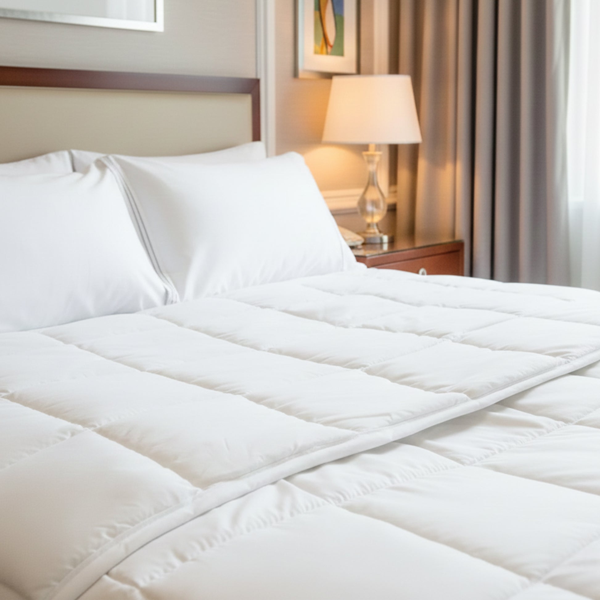 Valiant Products Ultra Touch FLEX white quilted microfiber down alternative blanket on a hotel bed