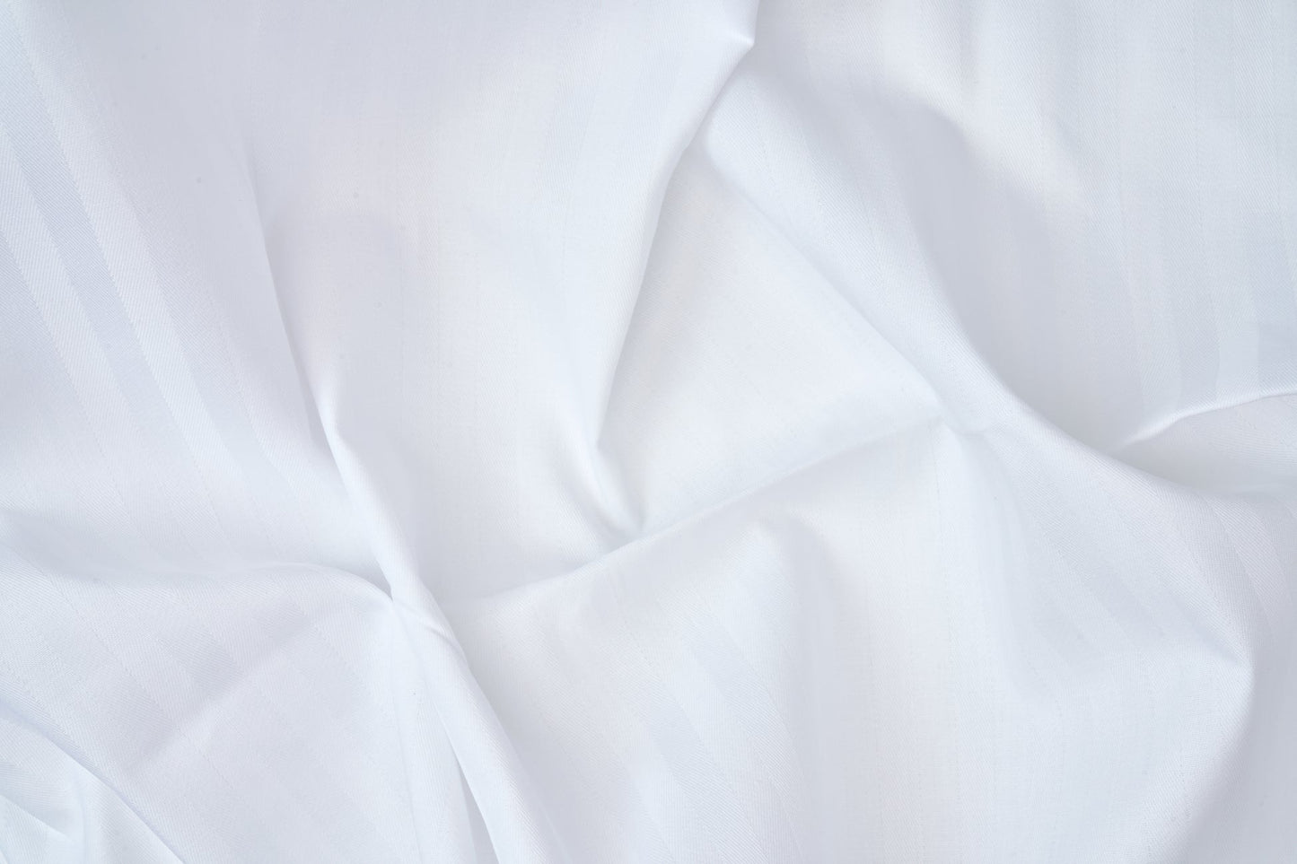 Valiant Products white T-250 cotton blend flat sheet with an elegant tone-on-tone satin stripe weave texture.