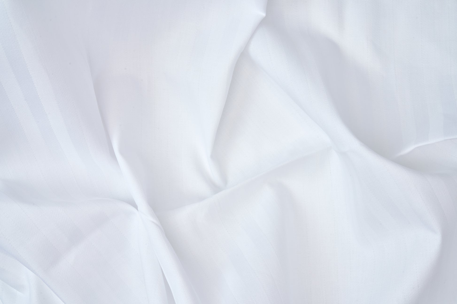 Valiant Products white T-250 cotton blend flat sheet with an elegant tone-on-tone satin stripe weave texture.