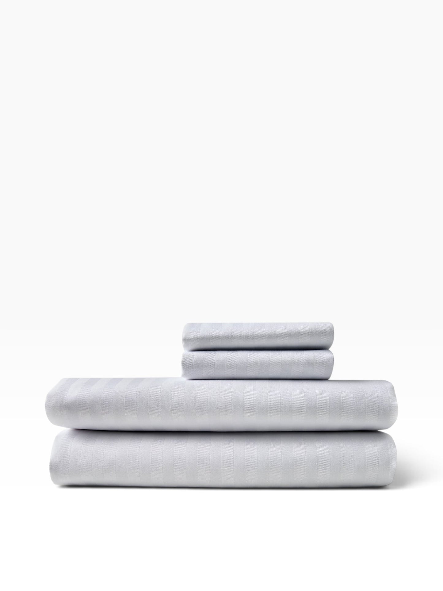 Valiant Products white striped pillowcases in a stack, featuring a 250 thread count cotton-polyester blend.